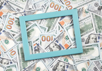 Lots of hundred dollar bills. Blue frame over cash money background. Top view
