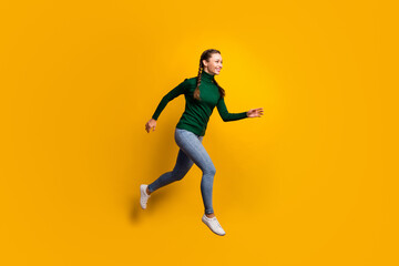 Fototapeta na wymiar Full length body size side profile photo laughing girl jumping high running fast isolated on vibrant yellow color background
