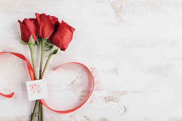 three red flowers with love card and copy space