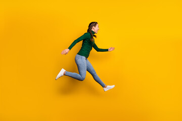 Fototapeta na wymiar Full length body size view of pretty cheerful girl jumping running fast motivation isolated on bright yellow color background