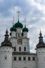 Fototapeta na wymiar Russia, Rostov, July 2020. Watchtowers and domes of churches against the background of the cloudy sky.