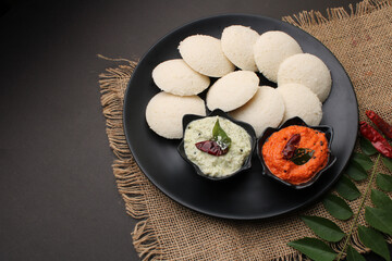 Idly sambar or Idli with Sambhar and green, red chutney. Popular South indian breakfast