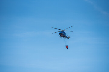 helicopter flying in the sky prepared to firefight - hill Ještěd