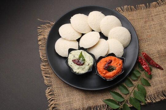 Idly sambar or Idli with Sambhar and green, red chutney. Popular South indian breakfast