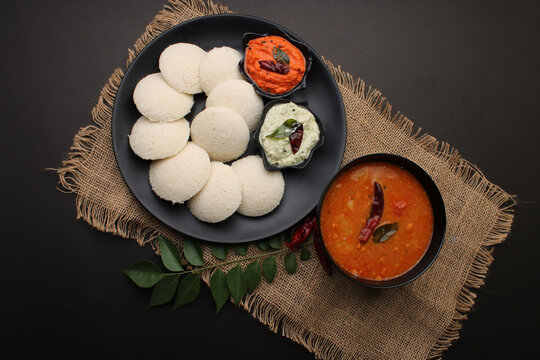 Idly sambar or Idli with Sambhar and green, red chutney. Popular South indian breakfast
