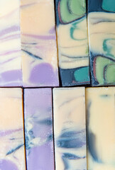 Colorful pieces of handmade soap lie in rows. Rough surface texture. Zero waste concept