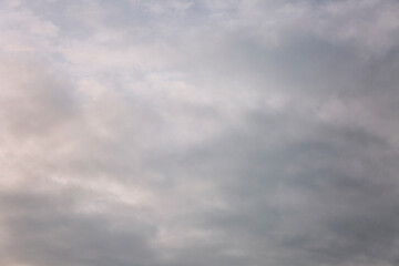Obraz premium Beautiful blue dramatic sky with clouds at sunrise. Background. Space for text.