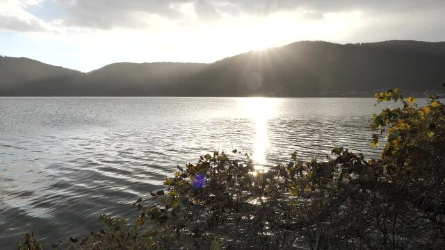 Lake Yogo illuminated by the intense backlighting from the mountains at sunset.