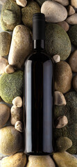 Bottle of red wine on the stones. Mockup presentation