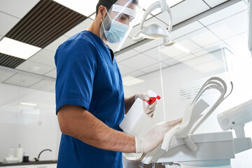 Dentist sterilize the medical equipment inside a dental clinic
