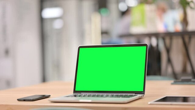 Open Laptop with Green Chroma Key Screen on Table, Close up 