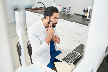 Fototapeta premium Doctor consulting patient while making online video call
