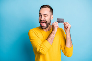 Photo portrait of student demonstrating debit card smiling winking blinking isolated on vibrant...