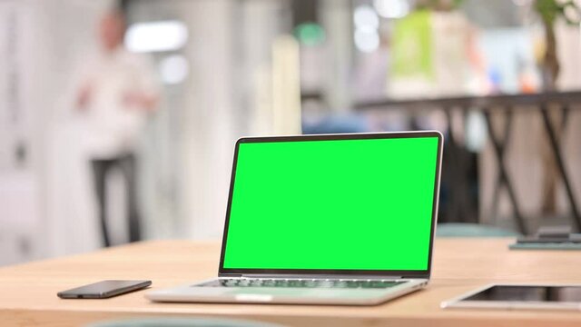 Laptop with Green Chroma Key Screen in Office