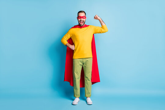 Full length body size photo of hero wearing costume mask showing strong muscles isolated on bright blue color background