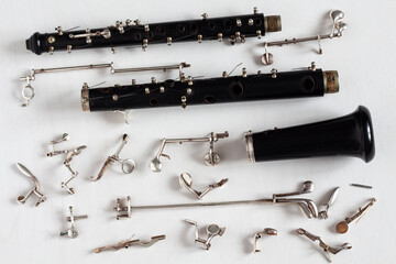 Old broken oboe. Repair of musical instruments. - obrazy, fototapety, plakaty