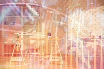 Double exposure of financial graph drawing and office interior background. Concept of stock market.