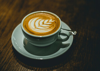 cup of coffee latte with milk on wooden table with copy space 