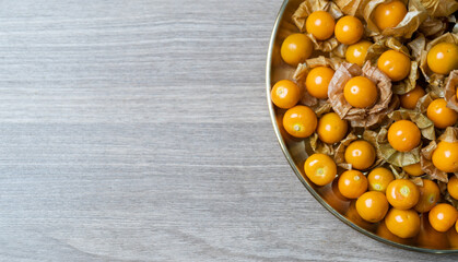 Top view pile of cape gooseberry fruit  in the gold plate.