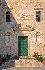 Fototapeta na wymiar Gate of the medieval temple of Church of Our Lady on the Rocks in Perast, Montenegro
