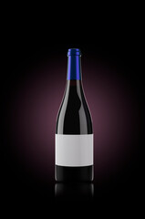 Bottle of red wine in a dark background