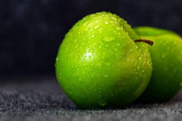 Fresh, bright, juicy green granny smith apples in water droplets