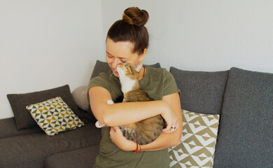 Girl holding a cat in her arms