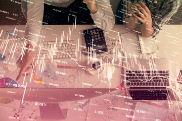 Double exposure of man and woman working together and financial chart hologram drawing. market analysis concept. Computer background. Top View.