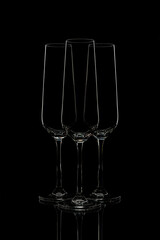 Elegant champagne flutes on black background.