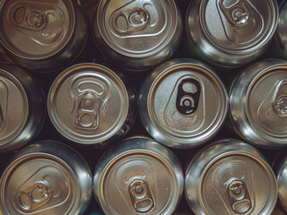 The tops of a selection of beer cans.