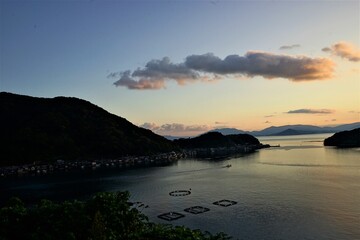 Fototapeta premium Aerial View of Ine bay and Funaya, boat houses, with beautiful sunset from Observation deck in Autumn, Ine city, Kyoto, Japan - 京都 舟屋群展望所から見た伊根湾の夕日