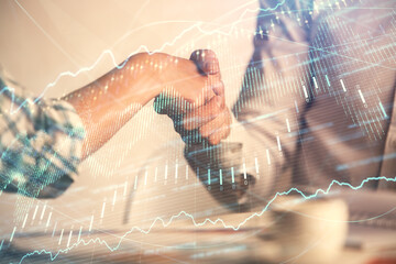 Double exposure of forex graph hologram and handshake of two men. Stock market concept.