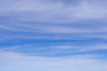 Fototapeta premium Aerial view of cloudscape seen through the airplane window. Space for text