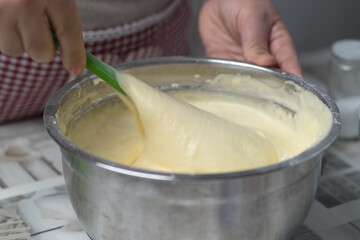 mixing the pastry dough in a stainless steel bowl
