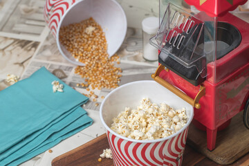 popcorn machine and bucket on a wooden table