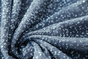 Macro photography of grey glitter with a blue hint. Textured sparkle glitter fabric with a wavy...