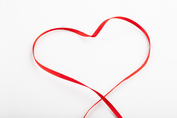 Red ribbon heart on white background