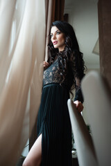 Obraz premium Young beautiful woman wearing black evening dress posing before Valentine dating 