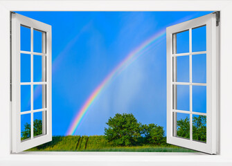 view from the window to the sky with a rainbow