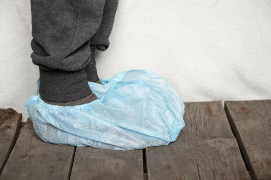 Female Legs In Blue Medical Protective Plastic Shoe Covers