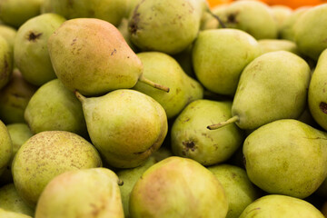 appetizing pears on counter in market