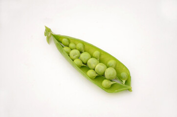 the green ripe peas with red carrot and turnip isolated on white background.