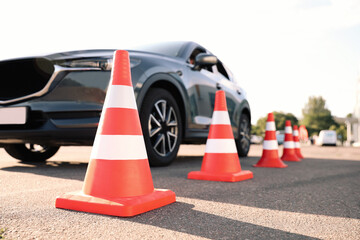 Traffic cones near car outdoors. Driving school exam