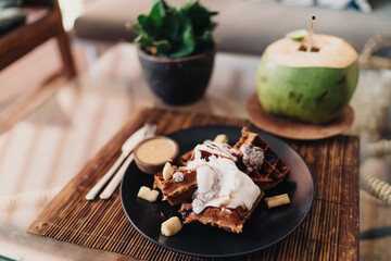 Tasty chocolate dessert with waffle served on bamboo mat