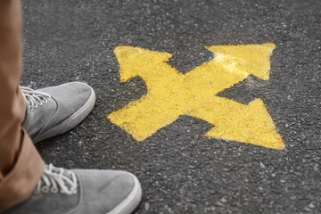 Man standing near arrow on asphalt, closeup