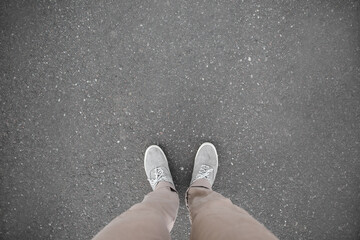 Man standing on asphalt road, top view. Space for text