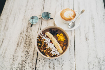 Cup of coffee and breakfast bowl with yogurt