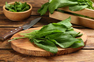 Fresh green sorrel leaves on wooden table, closeup