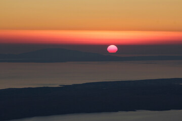 Sun hiding behind horizon of Adriatic sea.