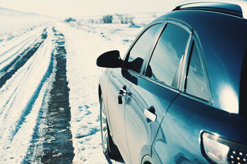 The four-wheel drive car of the modern SUV remains on the side of the winter road.